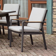 FOA East ALYCIA outdoor dining arm chair with cushion, shown in a neutral finish