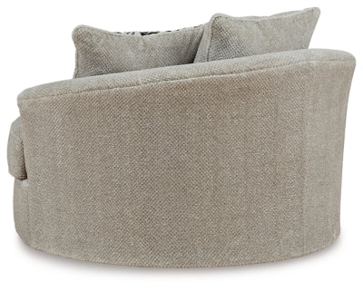 Ashley Furniture Calnita oversized swivel accent chair with plush upholstery and a contemporary design, shown from the back.