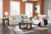 Ashley Furniture Danum upholstery living room set featuring a sofa and armchair in neutral fabric with plush cushions.