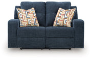 Ashley Furniture Danum reclining loveseat with plush fabric and cushioned armrests, shown in a head-on view.