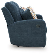 Ashley Furniture Danum recling loveseat with plush cushions and dark upholstery, shown from a side angle.