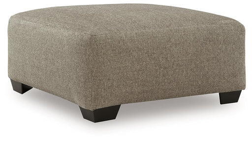 Ashley Furniture Newellen oversized accent ottoman with plush fabric and modern design, shown from an angled view.