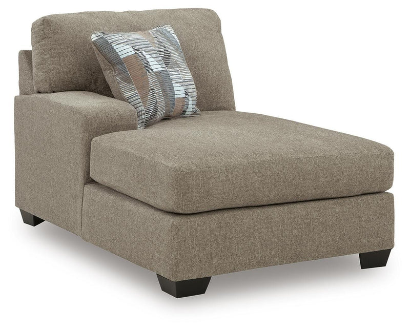 Ashley Furniture Newellen sleeper sectional with chaise, featuring plush cushions and a modern design in a spacious living room setting.