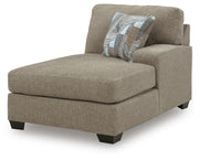 Ashley Furniture Newellen sleeper sectional with chaise, showing plush fabric upholstery and modern design from an angled view.