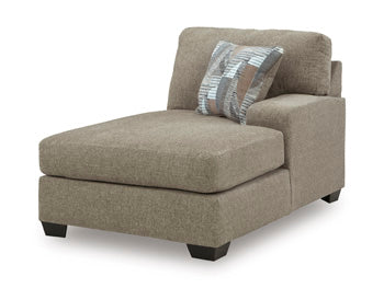 Ashley Furniture Newellen sleeper sectional with chaise, featuring plush upholstery and modern design, shown from an angled view.