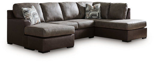 Ashley Furniture Castille Way sleeper sectional with chaise, featuring plush upholstery and modern design in a spacious living room setting.