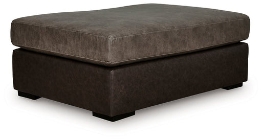 Ashley Furniture Castille Way oversized accent ottoman with plush fabric and tufted top, shown from an angled side view.
