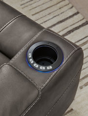 Ashley Furniture Feazada power recliner with armrest, side cup holder, and headrest, showcasing a comfortable and modern recliner design.