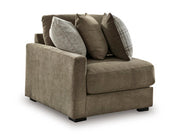 Ashley Furniture Camellia-Court sectional sofa shown from an angle, featuring plush cushions and modern design in a spacious living room setting.