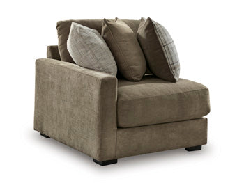 Ashley Furniture Camellia-Court sectional sofa shown from an angle, featuring plush cushions and modern design in a spacious living room setting.
