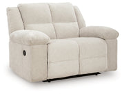 Ashley Furniture Orlen oversized recliner in brown leather, viewed from an angle showing the plush backrest and wide armrests.