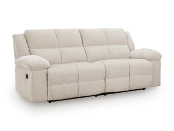 Ashley Furniture Orlen reclining sofa with plush cushions and reclining feature, shown from an angled view.