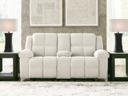 Ashley Furniture Orlen reclining loveseat with console, featuring plush fabric, padded armrests, and built-in cup holders.