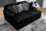 Ashley Furniture Midnight-Madness Super Chaise sectional in dark upholstery with plush cushions and modern design.