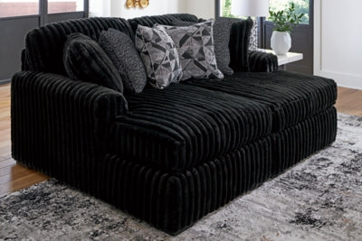 Ashley Furniture Midnight-Madness Super Chaise sectional with plush gray fabric and modern design, shown with multiple seating sections.