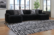 Ashley Furniture Midnight-Madness sectional with chaise, modern fabric sofa with plush cushions and chaise lounge in a stylish living room.