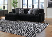 Ashley Furniture Midnight-Madness sectional sofa with chaise, showcasing plush upholstery and modern design in a stylish living room setting.