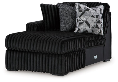 Ashley Furniture Midnight-Madness sectional with chaise, showing plush fabric, modern design, and spacious seating from an angled view.
