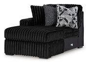 Ashley Furniture Midnight-Madness sectional with chaise, showing a stylish L-shaped sofa in a modern living room setting.