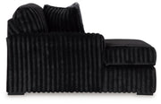 Ashley Furniture Midnight-Madness sectional with chaise, dark fabric, modern design, featuring plush cushions and a spacious layout.
