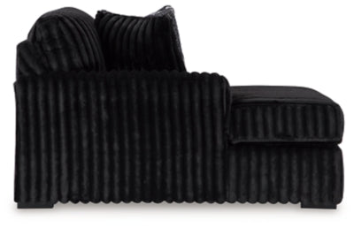 Ashley Furniture Midnight-Madness sectional with chaise, dark fabric, modern design, featuring plush cushions and a spacious layout.