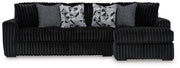 Ashley Furniture Midnight-Madness sectional sofa with chaise, featuring plush cushions and modern design in a cozy living room setting