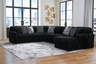 Ashley Furniture Midnight-Madness sectional with chaise, featuring dark upholstery and plush cushions for modern living comfort.