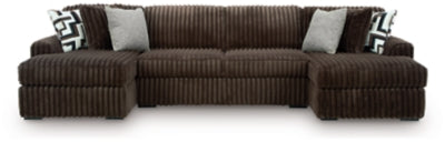 Ashley Furniture Midnight-Madness sectional with chaise, dark fabric upholstery, modern design, and plush cushions in a stylish living room.