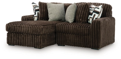 Ashley Furniture Midnight-Madness sectional with chaise, featuring plush upholstery and modern design, shown from an angled side view.