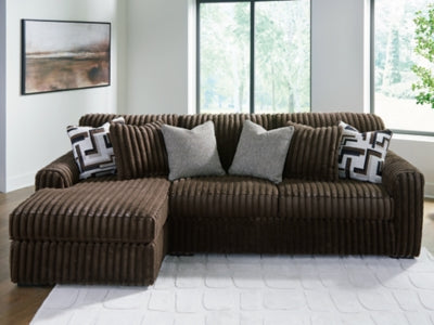 Ashley Furniture Midnight-Madness sectional sofa with chaise, showing plush fabric, modern design, and spacious seating arrangement.