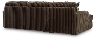 Ashley Furniture Midnight-Madness sectional sofa with chaise, featuring plush upholstery and a modern design in a stylish living room setting.