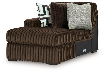 Ashley Furniture Midnight-Madness sectional with chaise, showing a stylish dark fabric sofa with a chaise lounge in a modern living room setting.