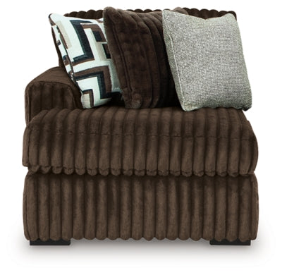Ashley Furniture Midnight-Madness sectional with chaise, featuring plush cushions and dark upholstery, in a head-on view.