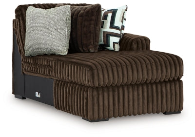 Ashley Furniture Midnight-Madness sectional with chaise, featuring plush fabric and modern design, shown from an angled side view.