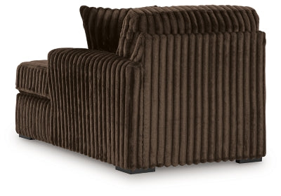 Ashley Furniture Midnight-Madness sectional with chaise, showing plush fabric, modern design, and spacious seating arrangement.