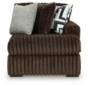 Ashley Furniture Midnight-Madness sectional with chaise, showing dark fabric and plush cushions in a stylish living room setting.