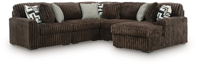 Ashley Furniture Midnight-Madness sectional with chaise, dark upholstered fabric, modern design, and plush seating in a stylish living room.