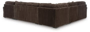 Ashley Furniture Midnight-Madness sectional with chaise, featuring plush cushions and modern design, viewed from the back.