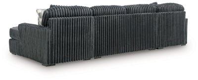 Ashley Furniture Midnight-Madness sectional with chaise, showing plush fabric and modern design from the back view.