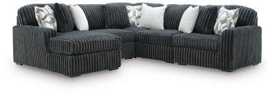 Ashley Furniture Midnight-Madness sectional with chaise, featuring plush fabric, modern design, and multiple seating areas.