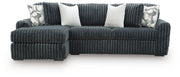 Ashley Furniture Midnight-Madness sectional sofa with chaise, showing plush fabric, modern design, and spacious seating arrangement.