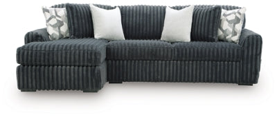 Ashley Furniture Midnight-Madness sectional sofa with chaise, showing plush fabric, modern design, and spacious seating arrangement.