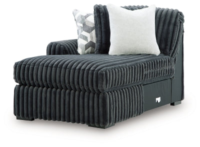 Ashley Furniture Midnight-Madness Super Chaise sectional in dark upholstery with plush cushions and a modern design, angled view.