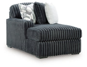 Ashley Furniture Midnight-Madness Super Chaise sectional in dark fabric, showing an angled side view with plush cushions and modern design.