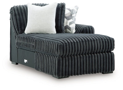 Ashley Furniture Midnight-Madness Super Chaise sectional with dark upholstery and plush cushions, viewed from an angled side.
