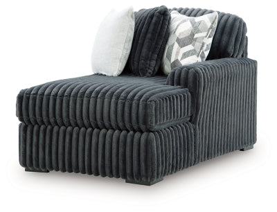 Ashley Furniture Midnight-Madness Super Chaise sectional in dark fabric with plush cushions, viewed from an angled side.