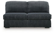 Ashley Furniture Midnight-Madness sectional with chaise, showing plush fabric, modern design, and spacious seating arrangement.