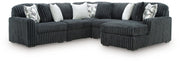Ashley Furniture Midnight-Madness sectional with chaise, featuring dark upholstery and plush cushions.