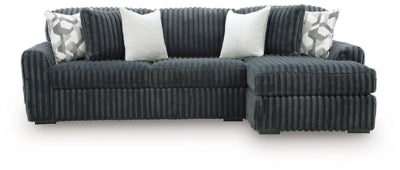 Ashley Furniture Midnight-Madness sectional sofa with chaise, dark fabric, modern design, and plush cushions in a stylish living room setting.