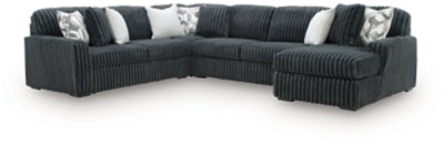 Ashley Furniture Midnight-Madness sectional with chaise, showing plush fabric and modern design in a cozy living room setting.